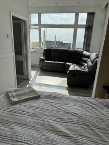 a living room with a couch and a bed at Lynton apartments in Blackpool