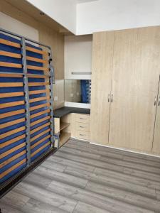 a kitchen with wooden cabinets and a large door at Lynton apartments in Blackpool