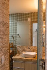 a bathroom with a sink and a mirror at Apartamentos Hotel Marinas in Tamandaré