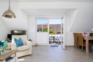a living room with a white couch and a table at Frieso am Siel in Greetsiel