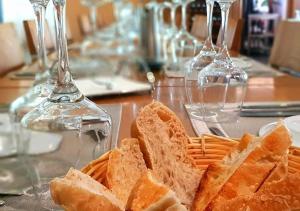 a basket of bread on a table with wine glasses at Beramar Hotel in Praia +23 photos