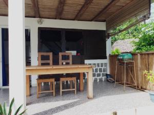 a wooden table and chairs on a patio at Blue Lagoon villa en bord de plage in Sainte Marie