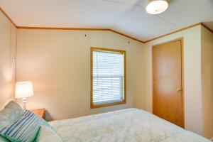 a bedroom with a bed and a window at Lake Texoma Cabin Near Willow Springs Marina! in Mead