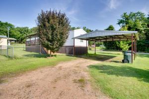a dirt road leading to a building with a shed at Lake Texoma Cabin Near Willow Springs Marina! in Mead