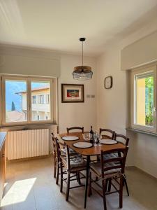 a dining room with a wooden table and chairs at Ersilia ed Ennio Apartment in Bellagio