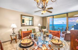 a living room with a table and chairs and a couch at Kahana Reef 315 by Coldwell Banker Island Vacations in Kahana