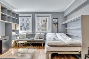 En eller flere senge i et værelse på Cozy Studio Retreat