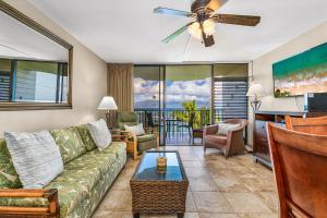 a living room with a couch and a ceiling fan at Kahana Reef 315 by Coldwell Banker Island Vacations in Kahana