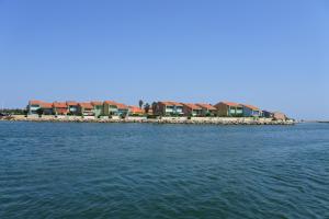a row of houses on the shore of a body of water at Studio 723 - village naturiste Aphrodite in Leucate-Plage