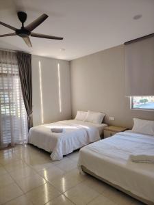 Ένα ή περισσότερα κρεβάτια σε δωμάτιο στο Relax Guest House Bakap Indah