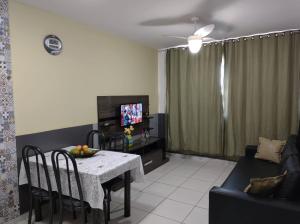 a living room with a table and a couch at Riviera Park Caldas Novas Temporada in Caldas Novas