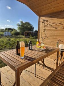 a wooden table with drinks and a plate of food at 402 Helles Tiny House im Grünen in Bleckede +7 photos