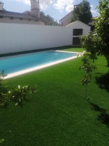 a backyard with a swimming pool and green grass at Casa di Felicita in Biograd na Moru