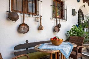 Una mesa con un bol de fruta y cubiertos. en Biobauernhof Toellerhof, en Lagundo