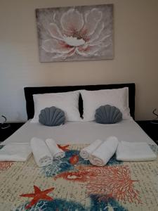 a bed with towels and pillows on it at Golden Panorama in Novalja