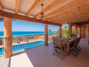 a dining room with a view of the ocean at Villa Armonia in Son Bou