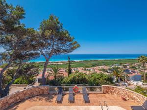 a patio with a view of the ocean at Villa Armonia in Son Bou
