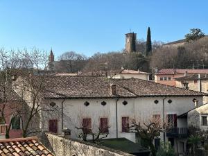 a white building with red windows in a city at Luxury Home in Volta Mantovana