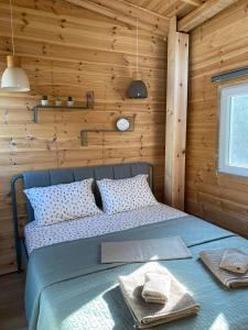 a bedroom with a bed in a wooden wall at Villa Haris in Sarti +48 photos