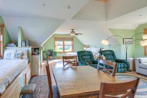 a living room with a bed and a table and chairs at Shared Dock and Fire Pit Peaceful Surry Studio! in Surry