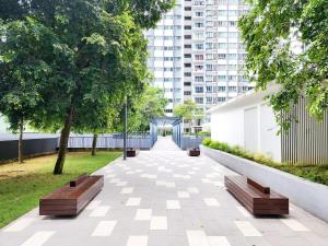 a park with two benches and a building at Southville Luxury Savanna Executive 3Bedroom in Kampung Dengkil