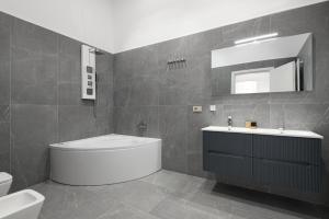 a bathroom with a tub and a sink and a toilet at Borghese Palace Luxury Apartment in Florence +42 photos