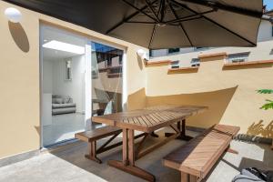 a dining room with a wooden table and benches at Borghese Palace Luxury Apartment in Florence