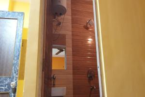 a bathroom with a shower and a mirror at Hotel O Eleven in Bhāgalpur +1 photo