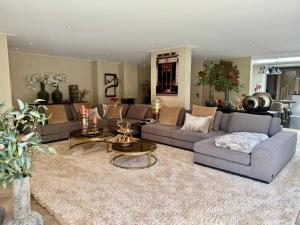a living room with couches and a rug at Vakantiewoning Casa Bergen Home in Bergen