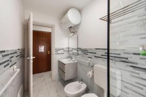 a bathroom with a sink and a toilet and a mirror at Domus Superba - Genova in Genova +22 photos