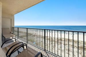 a balcony with chairs and a view of the beach at Phoenix X Unit 803 in Orange Beach