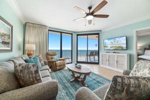 a living room with a view of the ocean at Phoenix X Unit 803 in Orange Beach +54 photos