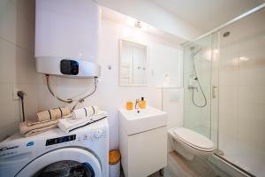 a bathroom with a washing machine and a sink at Flexible SelfCheckIns 172 - Zagreb - Center - New in Zagreb +11 photos