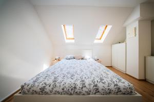 a bedroom with a bed in a room with skylights at Flexible SelfCheckIns 172 - Zagreb - Center - New in Zagreb