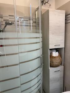 a shower with a glass door in a bathroom at A due passi dal mare - OpenSpace in Porto Garibaldi