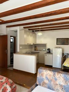 a kitchen with white cabinets and a white refrigerator at Apartments Marina in Vrsar