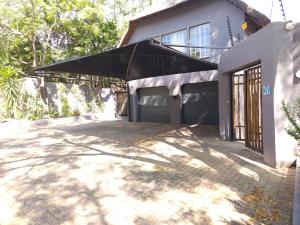 a large black umbrella hanging over a garage at Charming Loft-Style Appartment in Sandton