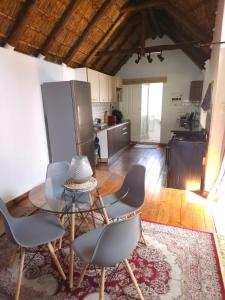 a living room with a table and chairs and a kitchen at Charming Loft-Style Appartment in Sandton