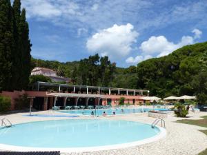a large swimming pool in front of a resort at Loggia di Capo d'Arco - Goelba in Capo D'Arco
