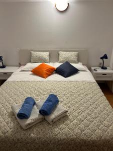 a bed with two pillows and two towels on it at Apartments Marina in Vrsar