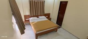 Postel nebo postele na pokoji v ubytování Hotel Tulsi