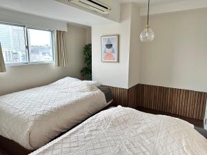 眺望抜群 高層階 錦糸町駅徒歩5分【浅草,秋葉原,新宿,成田,羽田アクセス】プロジェクタWiFi完備にあるベッド