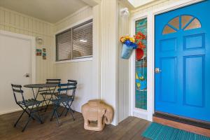 a room with a blue door and a table and chairs at Wave and Sea Monthly Only-Special Spring Rate in Cambria