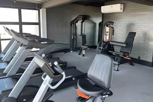 a gym with several tread machines in a room at Studio Concept Avenida das Esmeraldas in Marília