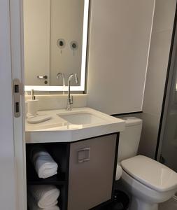 a bathroom with a sink and a toilet at Studio Concept Avenida das Esmeraldas in Marília +33 photos