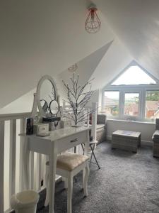 a white desk in a room with a window at The Hideaway-Sharples-Bolton in Bolton