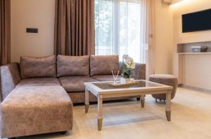 a living room with a couch and a coffee table at St Paul 25 Urban Apts in Kos Town