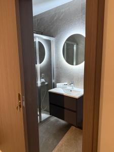 a bathroom with a sink and a mirror at Seaside Escape in St Paul's Bay +16 photos