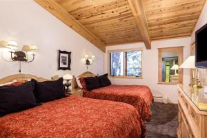 a hotel room with two beds and a television at Aspen Alps Apartment #209 in Aspen