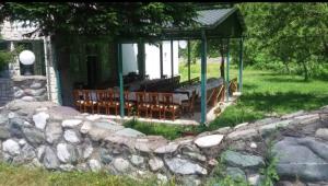 a group of chairs sitting outside of a building at Motel Tara in Mojkovac +5 photos